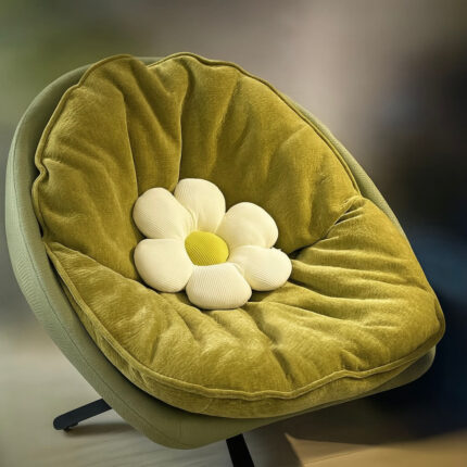 Fauteuil cocon pivotant en tissu chenille texturé vert mousse avec coussin fleur intégrée.
